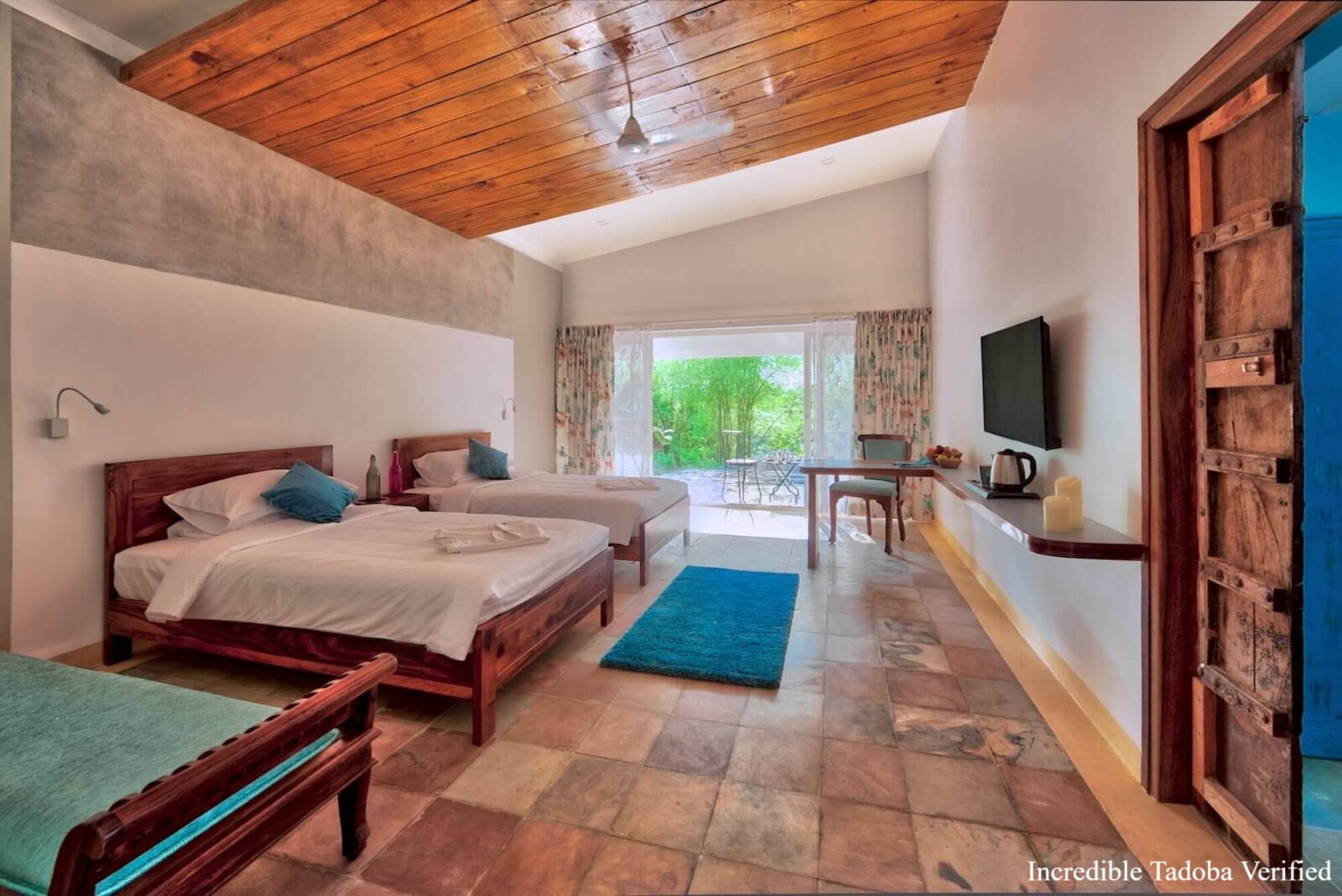 A bright twin-bed room with a view of the garden